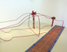 Untitled, 2003, iron, wallpaper, ribbons, 135 x 480 x 180 cm